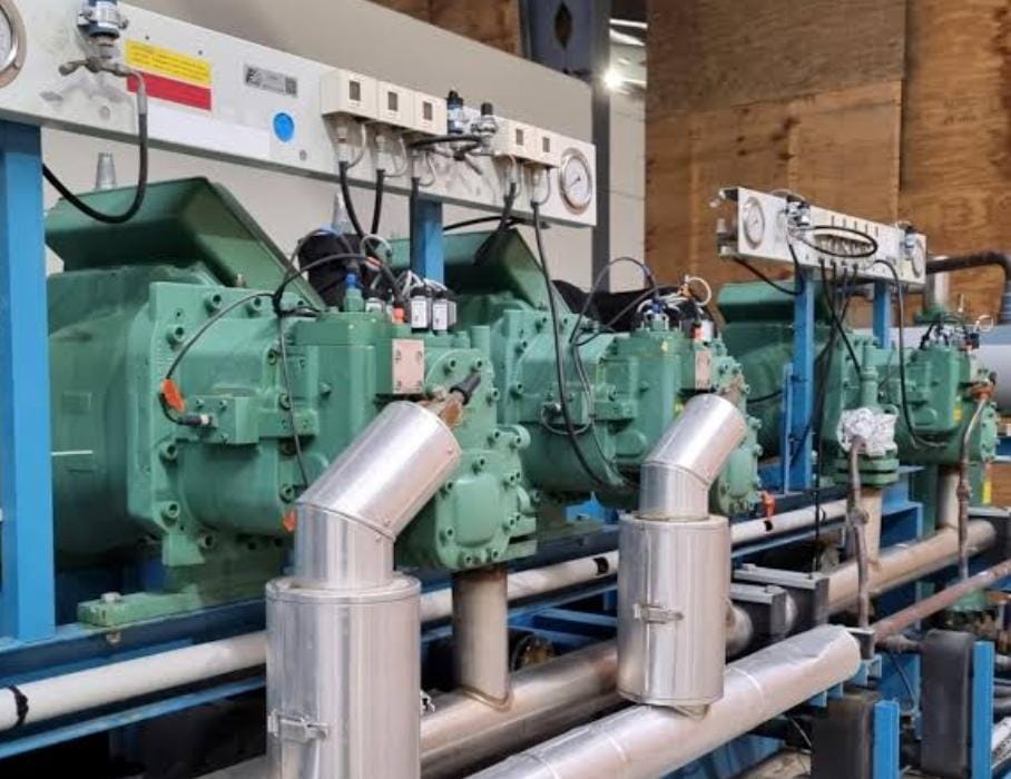 Multi-compressor rack with insulated suction headers and oil separators mounted on a steel frame
