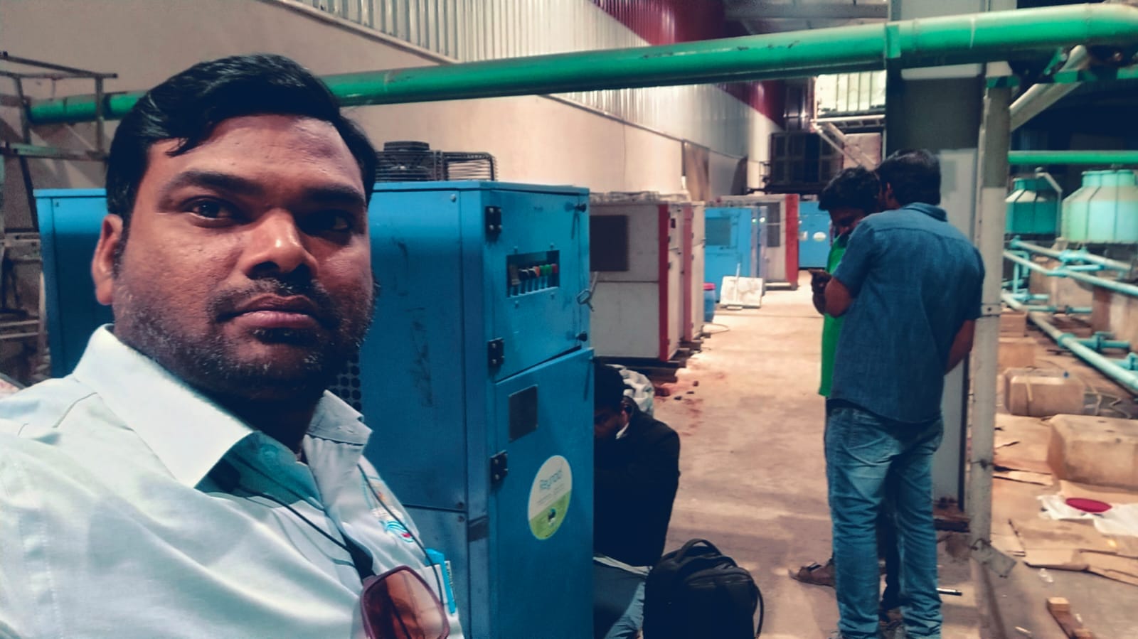 Star Tech Cooling engineer with the chiller line-up and process pipework inside the plant
